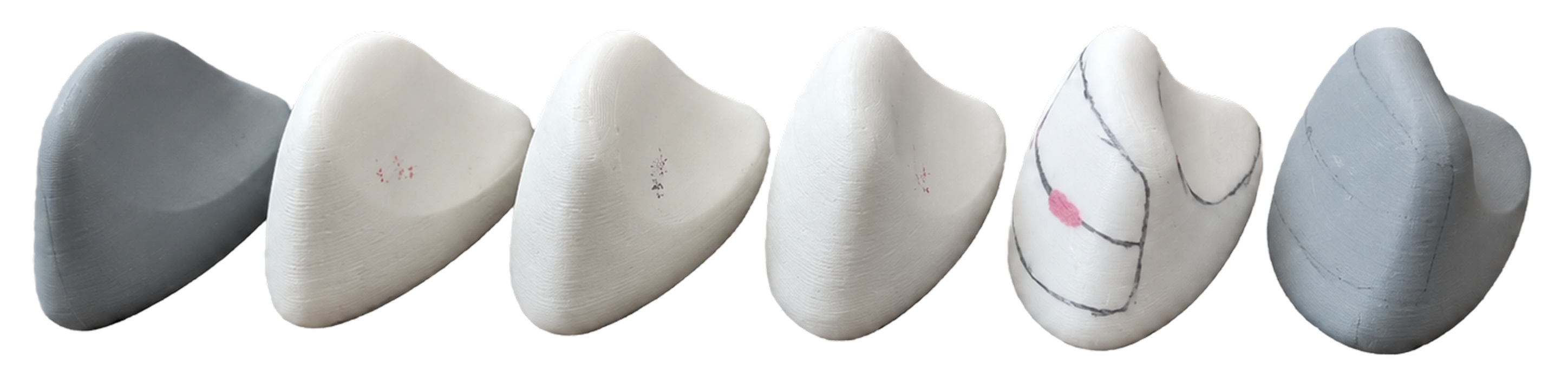 Six physical Pebble models in foam and 3D print, varying in body form, marked with thumb contact points and button placement lines from user testing